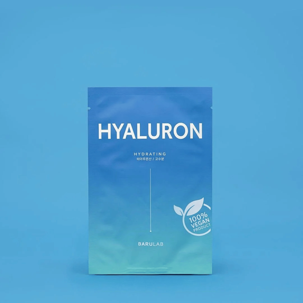En förpackning av BARULAB "HYALURON Hydrating" mask, märkt som "100% Vegan Product", framför en enhetlig blå bakgrund. Förpackningen har en färggradient från mörkblått till ljusblått.