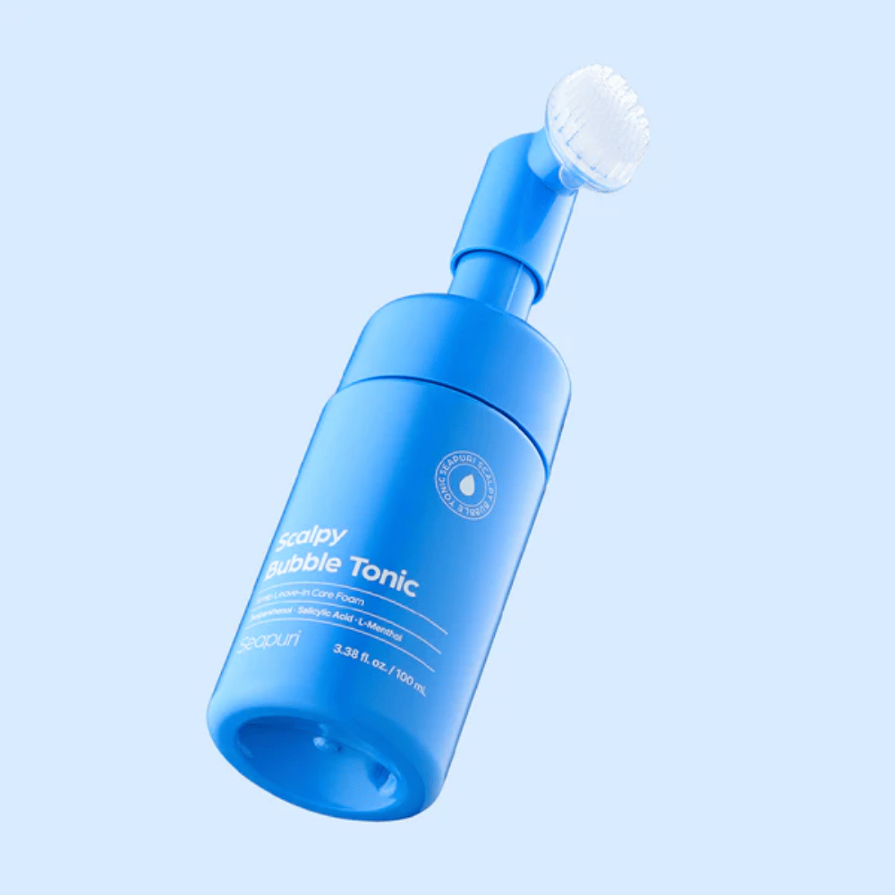 Stilren produktbild av Seapuri Scalpy Bubble Tonic mot ljusblå bakgrund som framhäver den moderna designen och den unika borstacken för hårbottenvård.