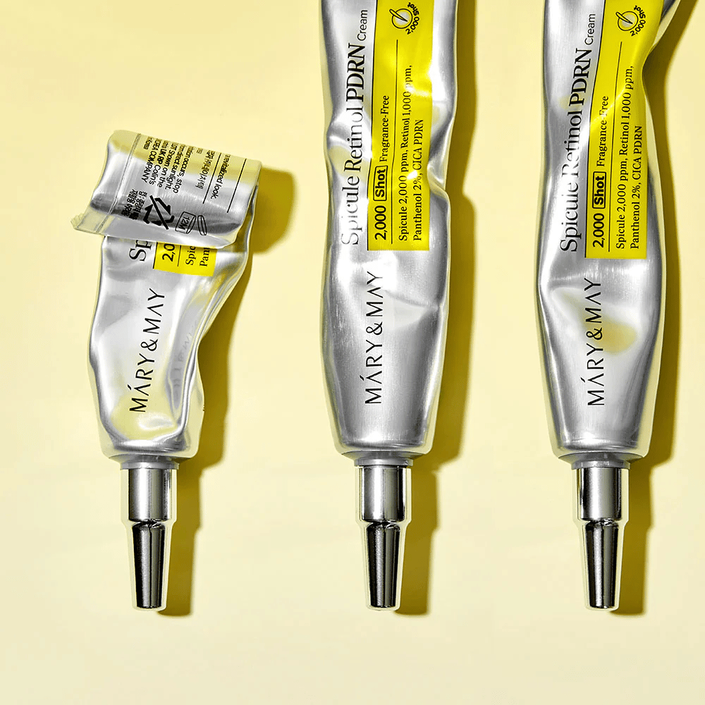 MARY & MAY Spicule Retinol PDRN Cream med synlig användning i tub, visar krämens konsistens och riktade applikator för exakt applicering på huden.