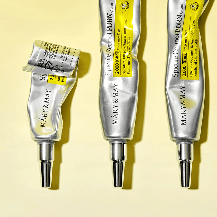 MARY & MAY Spicule Retinol PDRN Cream med synlig användning i tub, visar krämens konsistens och riktade applikator för exakt applicering på huden.